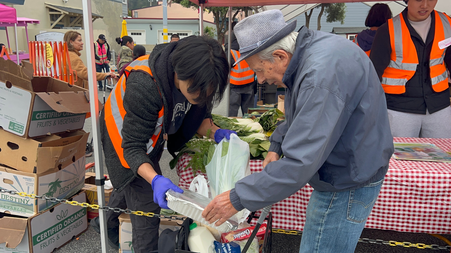 Helping an elder pack groceries