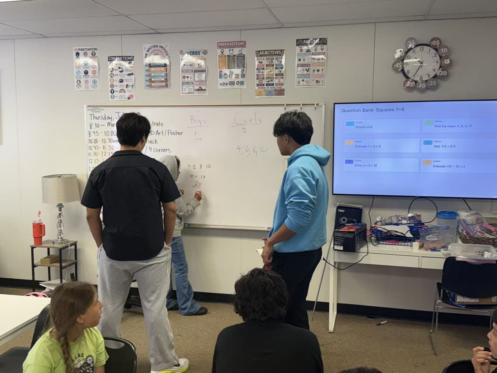 A camper working a problem on the board